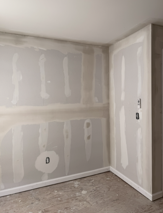 Home addition framing with taped and mudded drywall by Apex Residential